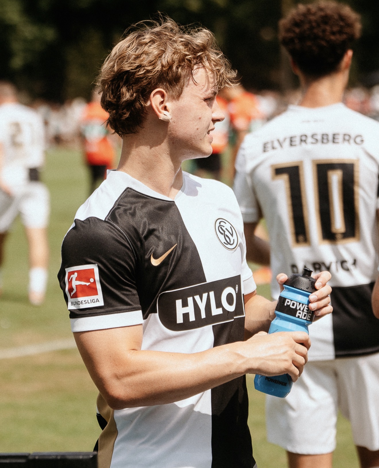 Cole Campbell holding a water bottle on the sideline